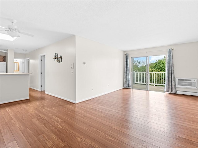 4430 Post Rd Unit 68E, Warwick, RI 02818 - unfurnished living room featuring a wall mounted air conditioner, light wood-style flooring, and a ceiling fan