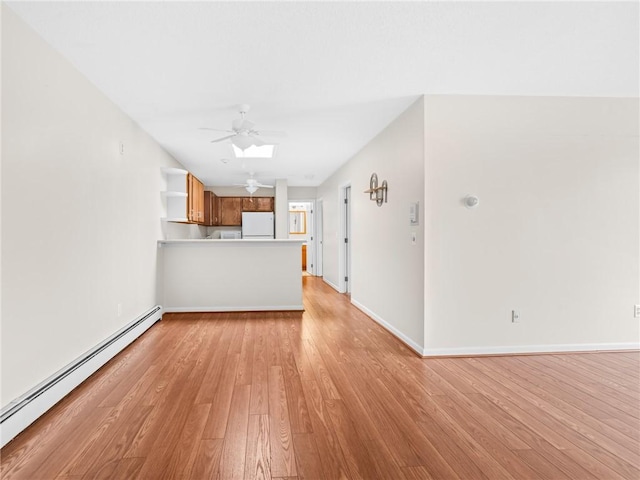 4430 Post Rd Unit 68E, Warwick, RI 02818 - unfurnished living room featuring a baseboard heating unit, ceiling fan, and light wood-style flooring