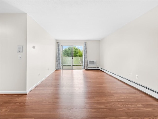 4430 Post Rd Unit 68E, Warwick, RI 02818 - empty room featuring wood-type flooring, a baseboard heating unit, and a wall mounted air conditioner