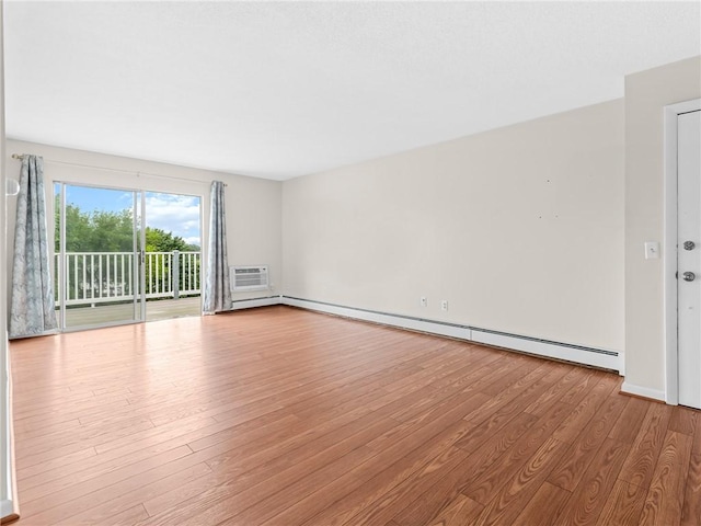 4430 Post Rd Unit 68E, Warwick, RI 02818 - empty room featuring wood finished floors, baseboard heating, and a wall mounted air conditioner
