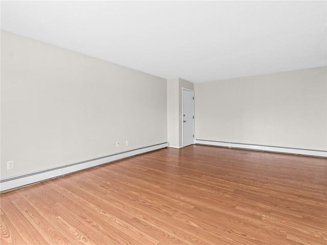 4430 Post Rd Unit 68E, Warwick, RI 02818 - unfurnished room featuring a baseboard radiator and wood finished floors