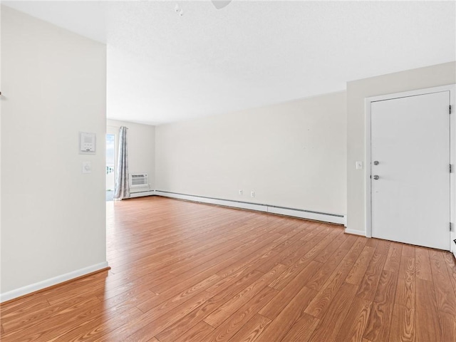 4430 Post Rd Unit 68E, Warwick, RI 02818 - empty room with baseboard heating, light wood-style floors, and a wall unit AC