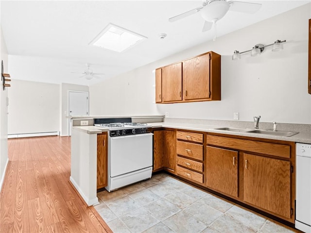 4430 Post Rd Unit 68E, Warwick, RI 02818 - kitchen with white appliances, ceiling fan, brown cabinetry, and a peninsula