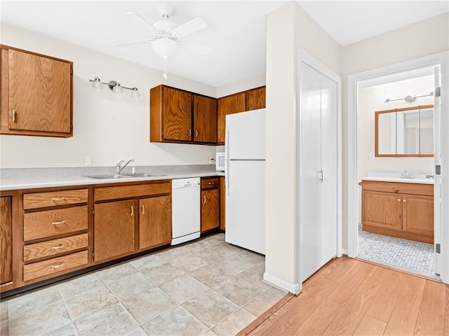 4430 Post Rd Unit 68E, Warwick, RI 02818 - kitchen with white appliances, brown cabinetry, light countertops, and a ceiling fan
