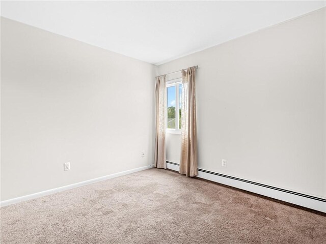 4430 Post Rd Unit 68E, Warwick, RI 02818 - spare room featuring carpet floors and a baseboard heating unit