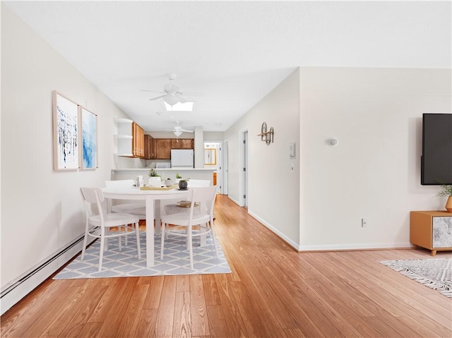 4430 Post Rd Unit 68E, Warwick, RI 02818 - dining space featuring baseboard heating, light wood-style flooring, and ceiling fan