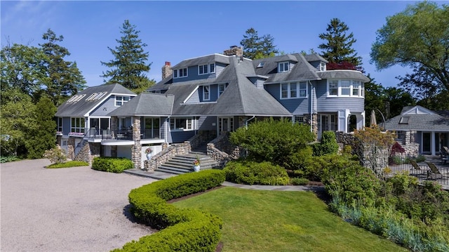 121 Avondale Rd, Westerly, RI 02891 - shingle-style home featuring stairs, a front yard, covered porch, and a chimney