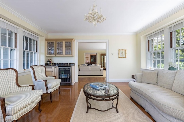 121 Avondale Rd, Westerly, RI 02891 - living area with wine cooler, a bar, wood finished floors, crown molding, and a chandelier