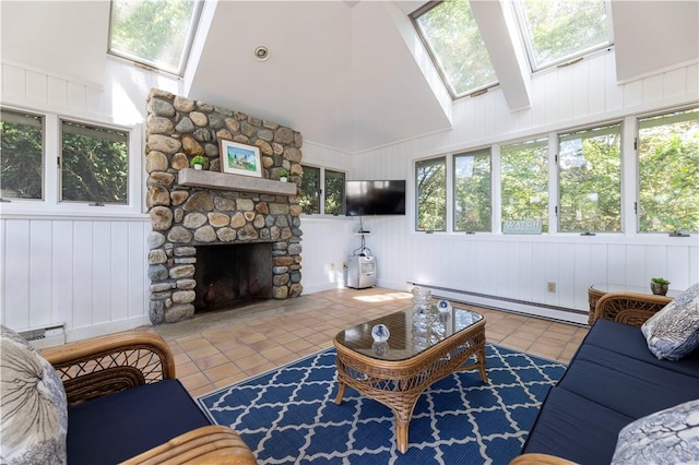 121 Avondale Rd, Westerly, RI 02891 - tiled living room featuring a baseboard heating unit, a skylight, high vaulted ceiling, a stone fireplace, and a decorative wall