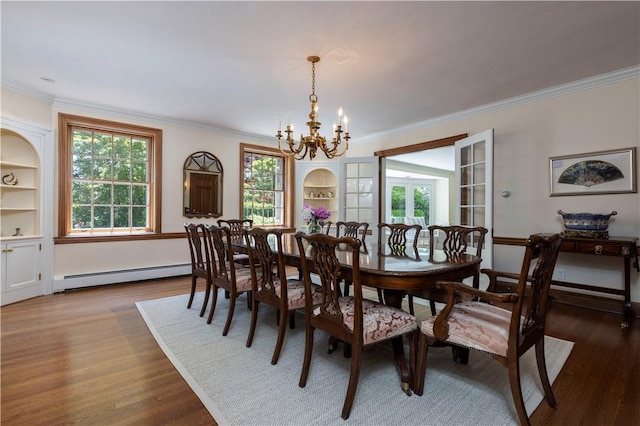 121 Avondale Rd, Westerly, RI 02891 - dining space featuring a baseboard heating unit, a chandelier, wood finished floors, and crown molding