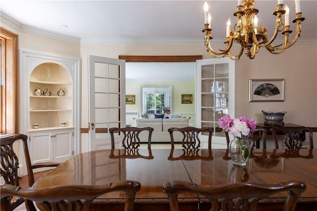 121 Avondale Rd, Westerly, RI 02891 - dining room with a chandelier, built in shelves, and ornamental molding