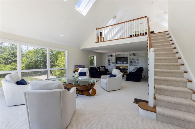 121 Avondale Rd, Westerly, RI 02891 - living room featuring high vaulted ceiling, stairs, carpet flooring, and a skylight