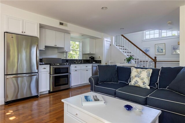 121 Avondale Rd, Westerly, RI 02891 - living room featuring stairway and dark wood-type flooring