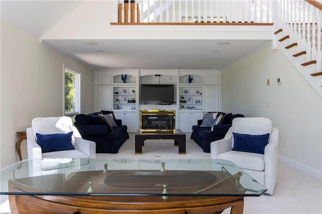121 Avondale Rd, Westerly, RI 02891 - living area featuring stairs, light carpet, a glass covered fireplace, and a high ceiling
