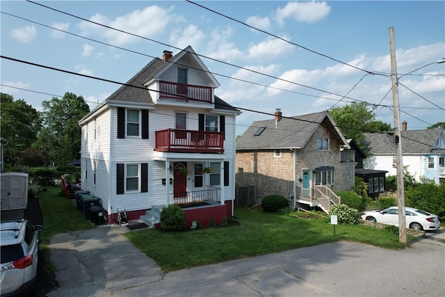 19 Remington St, Warwick, RI 02888 - view of front of home with a balcony, a front yard, and a chimney
