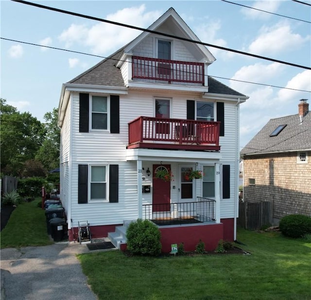 19 Remington St, Warwick, RI 02888 - view of front of house with a balcony, a front yard, and roof with shingles