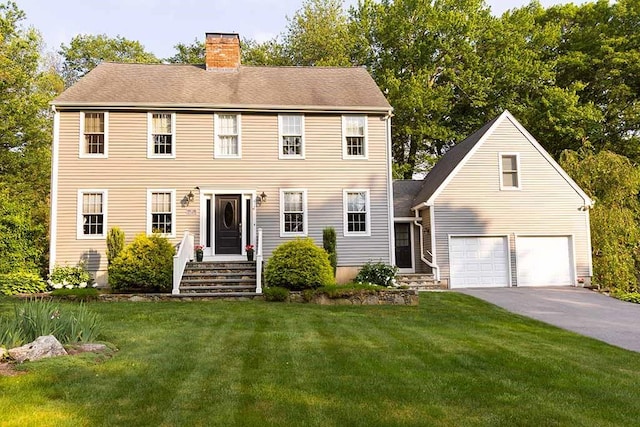 30 Karen Ann Dr, Smithfield, RI 02917 - colonial house featuring a chimney, a front yard, an attached garage, and asphalt driveway
