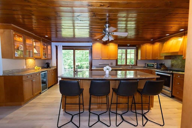 30 Karen Ann Dr, Smithfield, RI 02917 - kitchen featuring electric range, wine cooler, wood ceiling, custom exhaust hood, and a center island