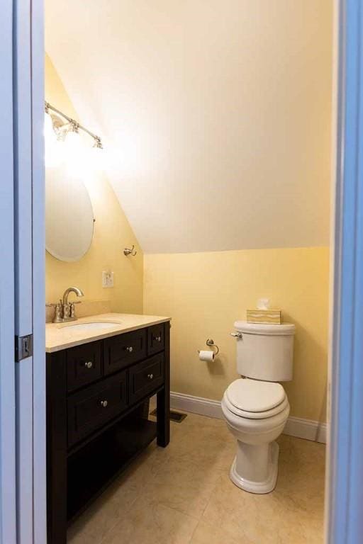 30 Karen Ann Dr, Smithfield, RI 02917 - half bathroom with vaulted ceiling, vanity, and tile patterned flooring