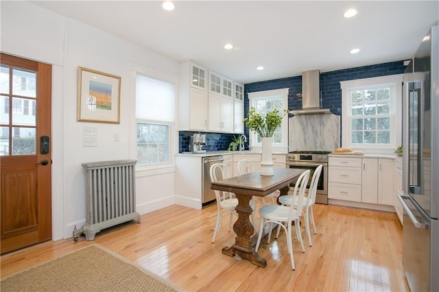 12 Poplar St, Newport, RI 02840 - dining area featuring light wood-type flooring, radiator heating unit, and recessed lighting