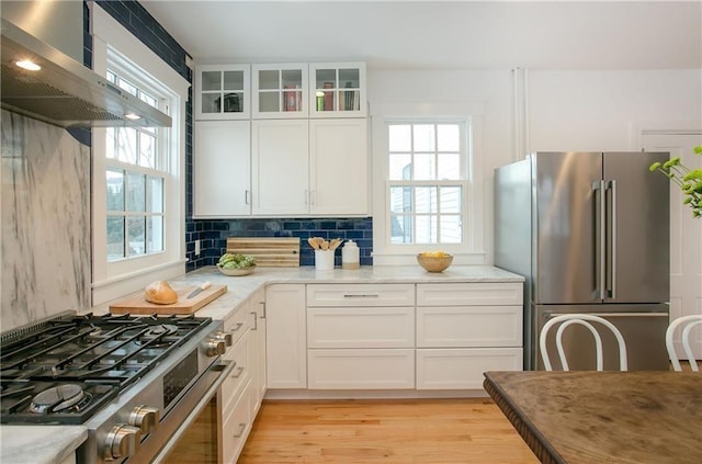 12 Poplar St, Newport, RI 02840 - kitchen featuring stainless steel appliances, ventilation hood, white cabinets, and light wood-style floors