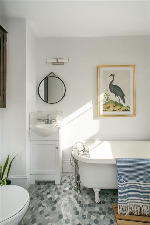 12 Poplar St, Newport, RI 02840 - full bath with a freestanding bath, vanity, and tile patterned flooring
