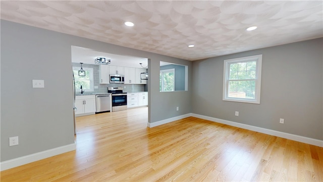 112 Cranberry Ridge Rd, Glocester, RI 02857 - unfurnished living room featuring plenty of natural light, light wood-type flooring, and recessed lighting