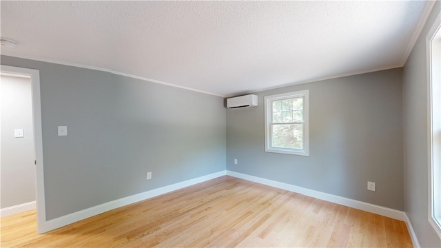 112 Cranberry Ridge Rd, Glocester, RI 02857 - empty room featuring a wall unit AC, ornamental molding, wood finished floors, and a textured ceiling
