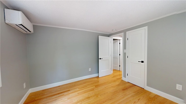 112 Cranberry Ridge Rd, Glocester, RI 02857 - empty room with an AC wall unit, light wood-type flooring, and crown molding