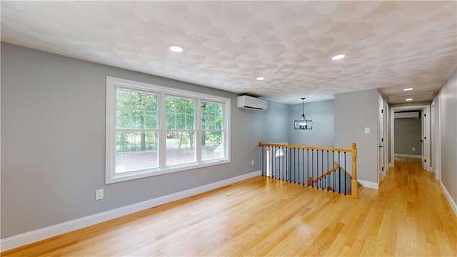112 Cranberry Ridge Rd, Glocester, RI 02857 - spare room with a wall mounted AC, a wall mounted air conditioner, light wood-style flooring, recessed lighting, and a chandelier