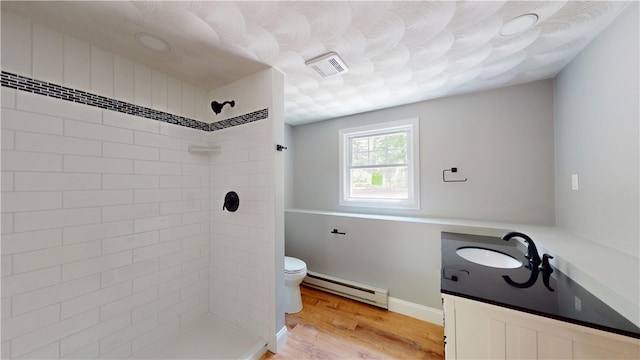 112 Cranberry Ridge Rd, Glocester, RI 02857 - bathroom with a baseboard heating unit, tiled shower, vanity, and wood finished floors
