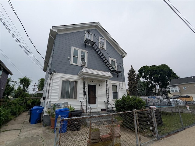 60 Sherman St, Pawtucket, RI 02860 - view of front facade with a fenced front yard, a gate, and entry steps