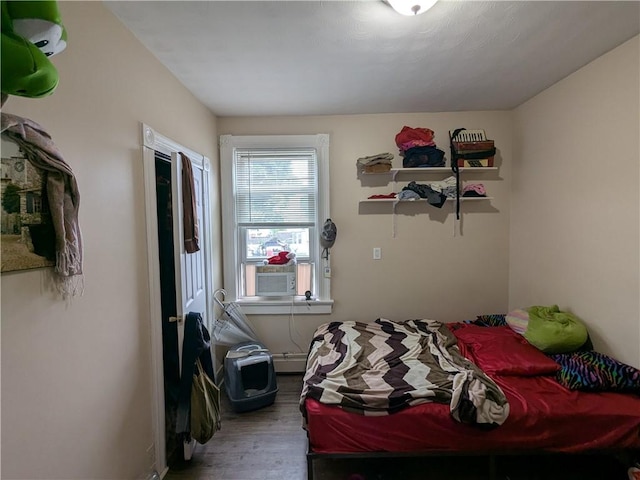 60 Sherman St, Pawtucket, RI 02860 - bedroom featuring wood finished floors, cooling unit, and a baseboard radiator