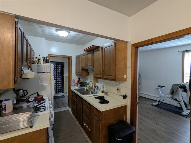 60 Sherman St, Pawtucket, RI 02860 - kitchen with dark wood-type flooring, light countertops, exhaust hood, white gas stove, and tasteful backsplash