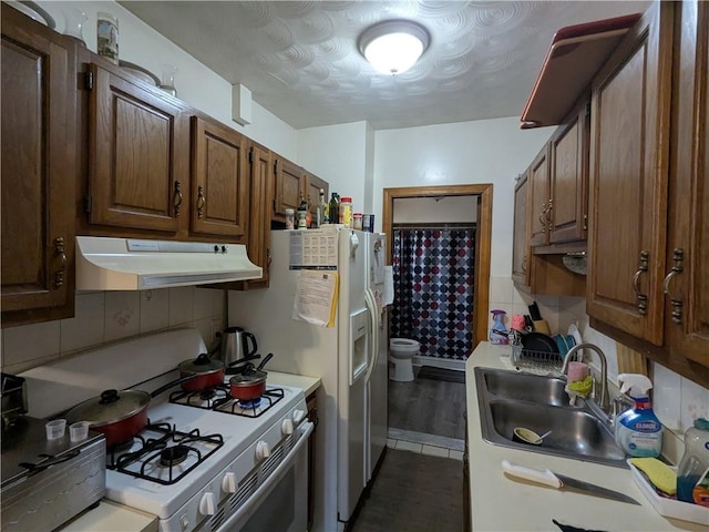 60 Sherman St, Pawtucket, RI 02860 - kitchen with under cabinet range hood, white appliances, light countertops, and decorative backsplash