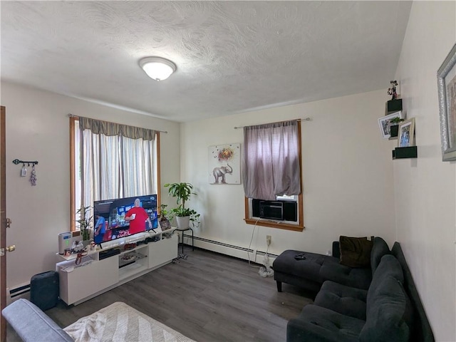 60 Sherman St, Pawtucket, RI 02860 - living area featuring a baseboard radiator, cooling unit, wood finished floors, a textured ceiling, and a baseboard heating unit