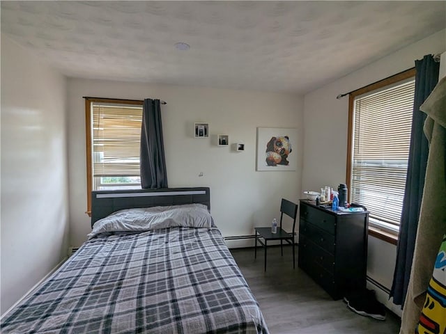 60 Sherman St, Pawtucket, RI 02860 - bedroom featuring wood finished floors and a baseboard heating unit
