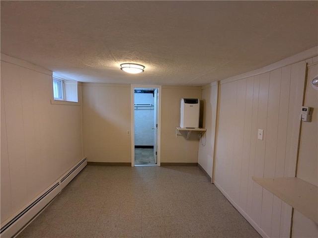 60 Sherman St, Pawtucket, RI 02860 - basement with a baseboard heating unit, a textured ceiling, and wooden walls