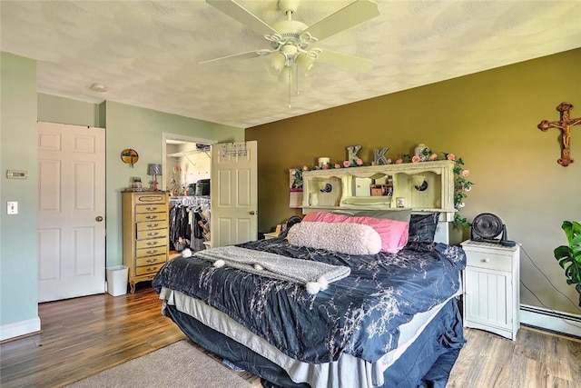 827 Anthony Rd, Portsmouth, RI 02871 - bedroom featuring wood finished floors, a walk in closet, a ceiling fan, and a closet