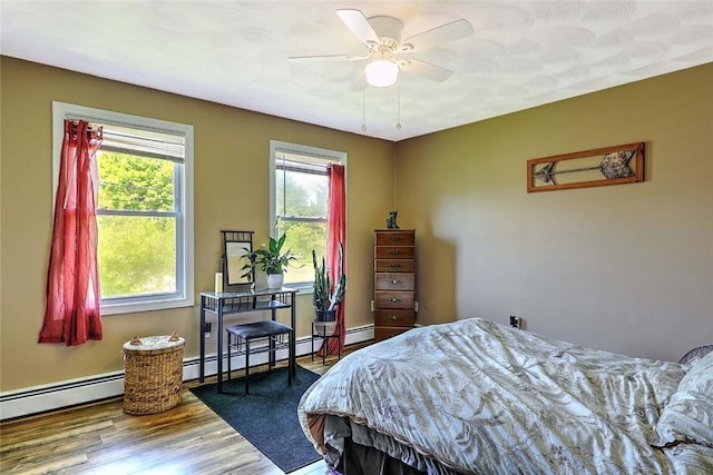827 Anthony Rd, Portsmouth, RI 02871 - bedroom with wood finished floors, a baseboard heating unit, baseboard heating, and ceiling fan