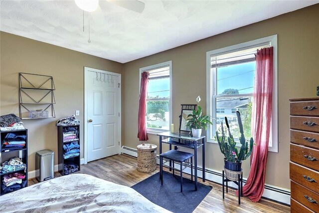 827 Anthony Rd, Portsmouth, RI 02871 - bedroom with wood finished floors and a baseboard heating unit
