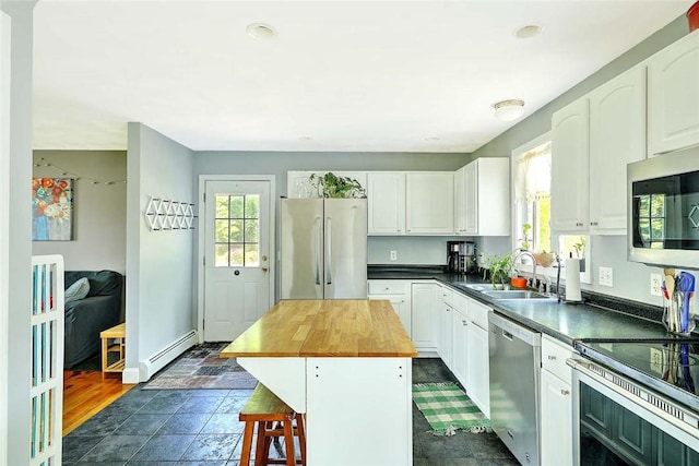 827 Anthony Rd, Portsmouth, RI 02871 - kitchen featuring appliances with stainless steel finishes, wood counters, white cabinets, and recessed lighting