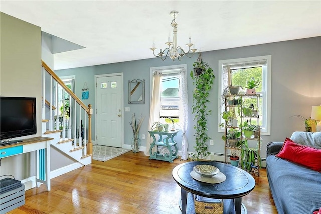 827 Anthony Rd, Portsmouth, RI 02871 - living room featuring a chandelier, stairs, hardwood / wood-style flooring, and a baseboard heating unit