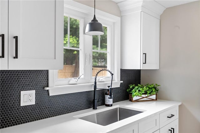 60 Webb Ave, Warwick, RI 02889 - kitchen with decorative backsplash, white cabinets, decorative light fixtures, and light countertops