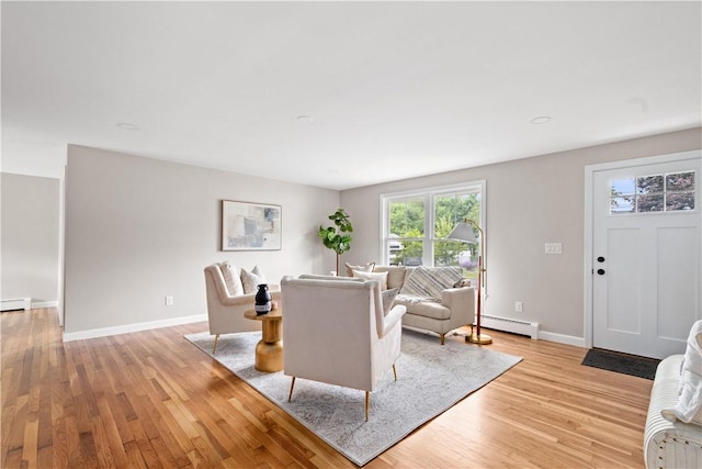 60 Webb Ave, Warwick, RI 02889 - living area with a baseboard heating unit and light wood-style flooring