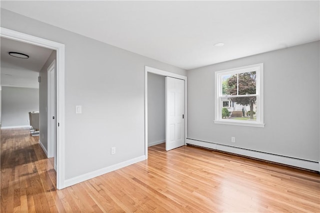 60 Webb Ave, Warwick, RI 02889 - unfurnished bedroom featuring light wood-style flooring, a baseboard heating unit, and a closet