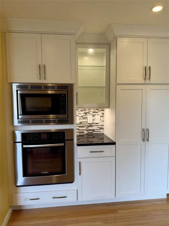 30 Hoover St, West Warwick, RI 02893 - kitchen featuring stainless steel appliances, white cabinetry, light wood-style floors, tasteful backsplash, and recessed lighting