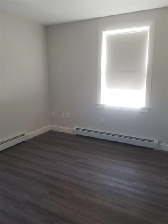 28 Portland St, Providence, RI 02907 - unfurnished room with a baseboard heating unit and dark wood finished floors