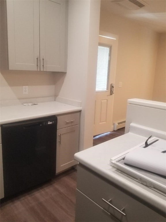 28 Portland St, Providence, RI 02907 - kitchen featuring dishwasher, a baseboard heating unit, dark wood-style flooring, and light countertops