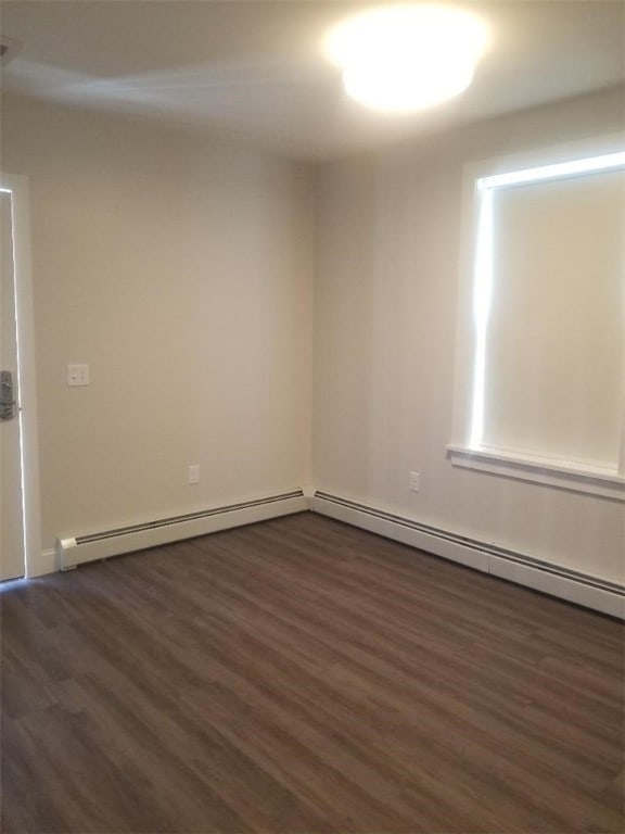 28 Portland St, Providence, RI 02907 - unfurnished room with dark wood-style floors and a baseboard heating unit